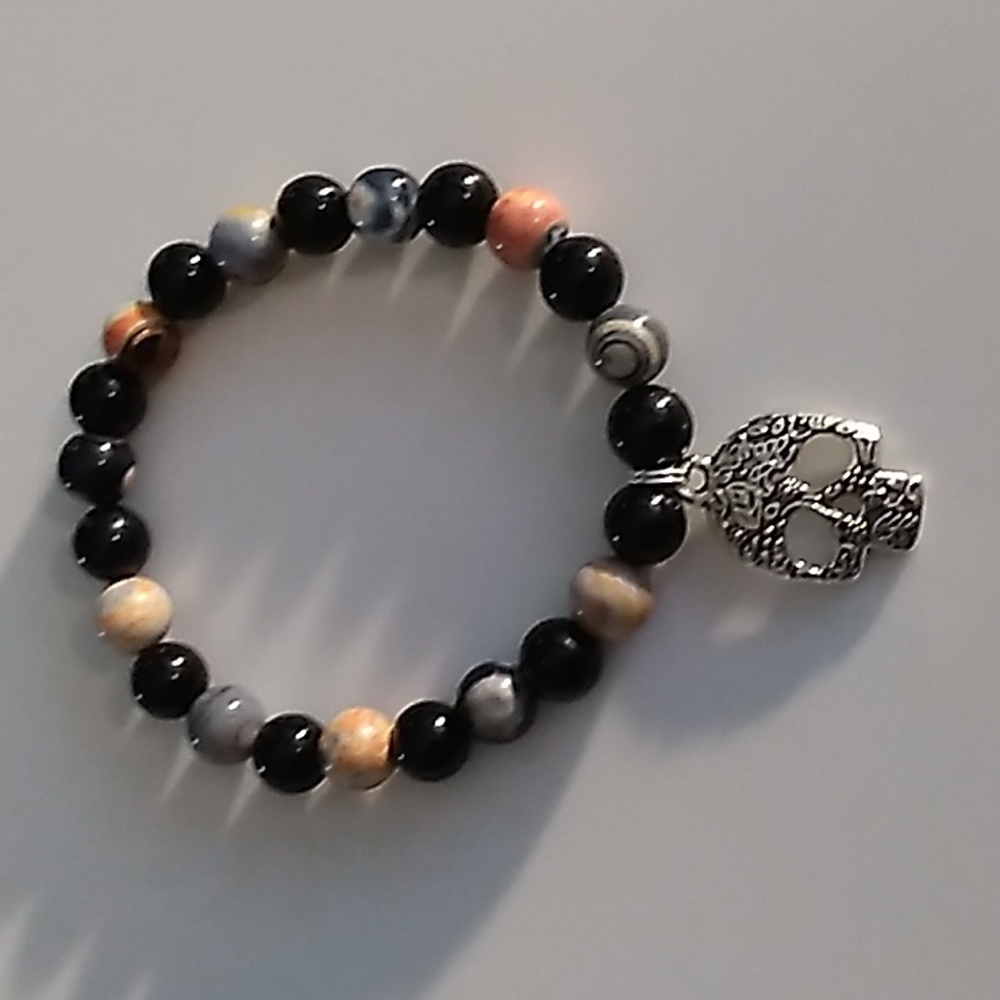 Orange and Black stretch bracelet with skull charm